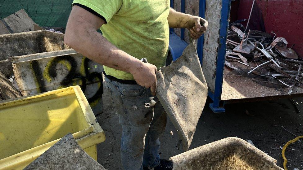 Nate sifts through trash and metal before sending it to a recycling facility