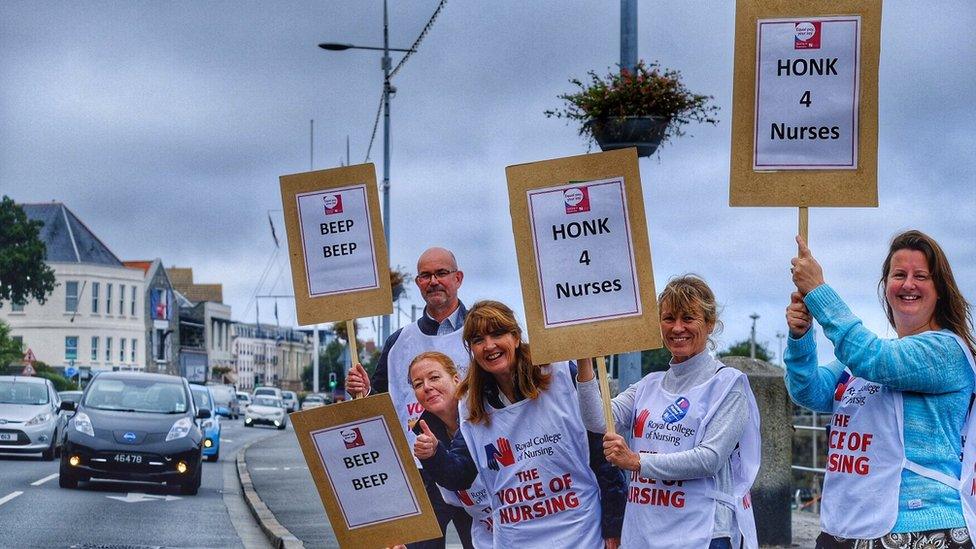 Nurses with placards.