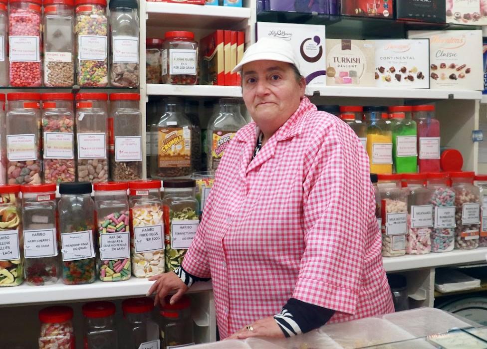 Shop assistant Gina Morgan inside Teddy Grays sweetshop. Dudley