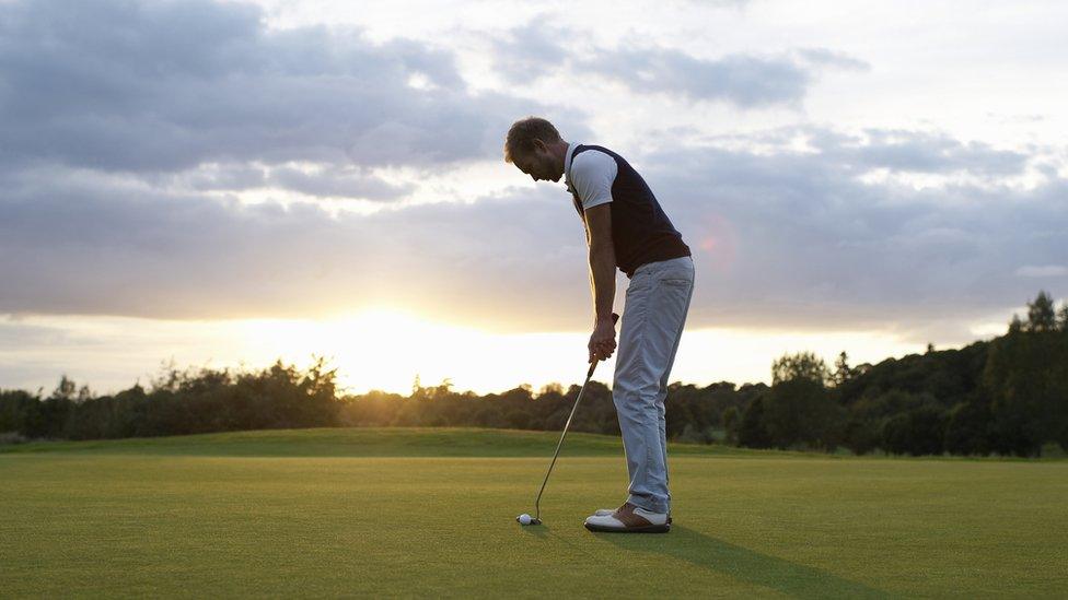 Stock image of a man golfing