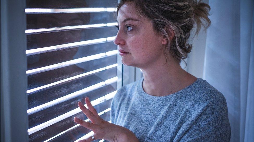 Woman looking out of the window