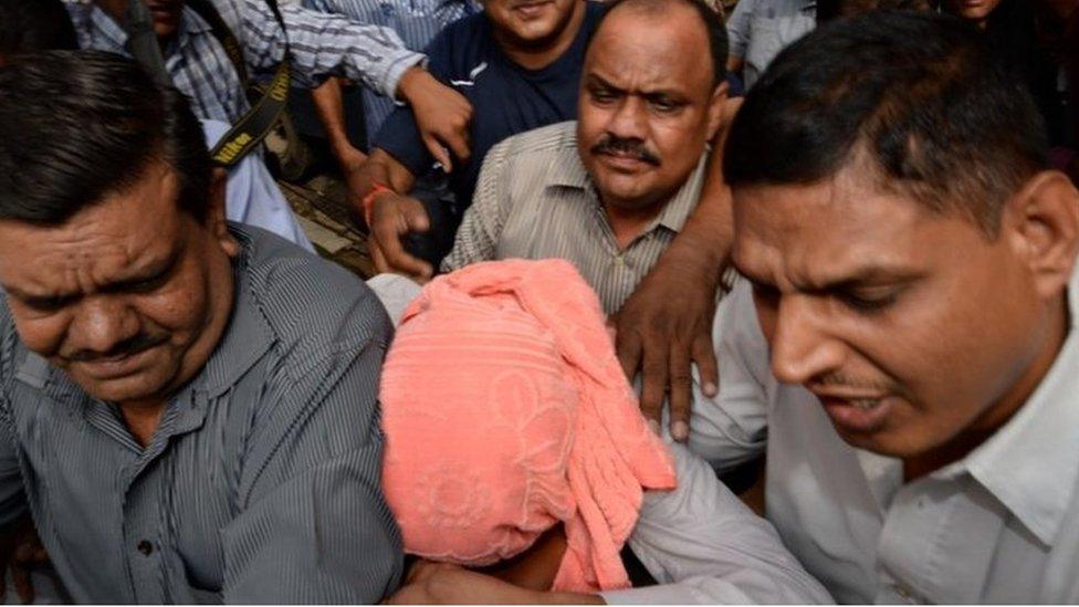 Indian policemen escort the juvenile (C, in pink hood), accused in the December 2012 gang-rape