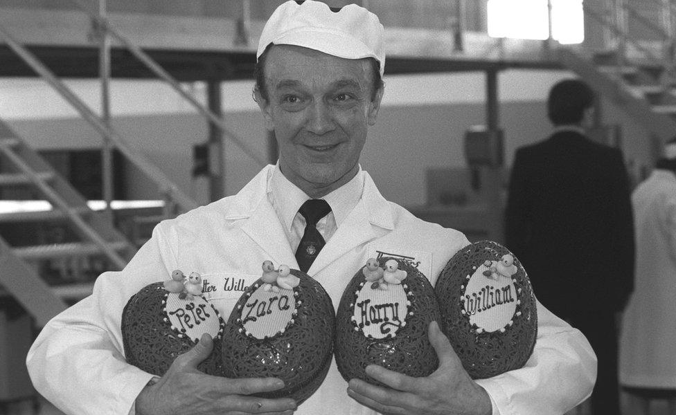 Walter Willen holds Easter eggs decorated for the Queen's grandchildren