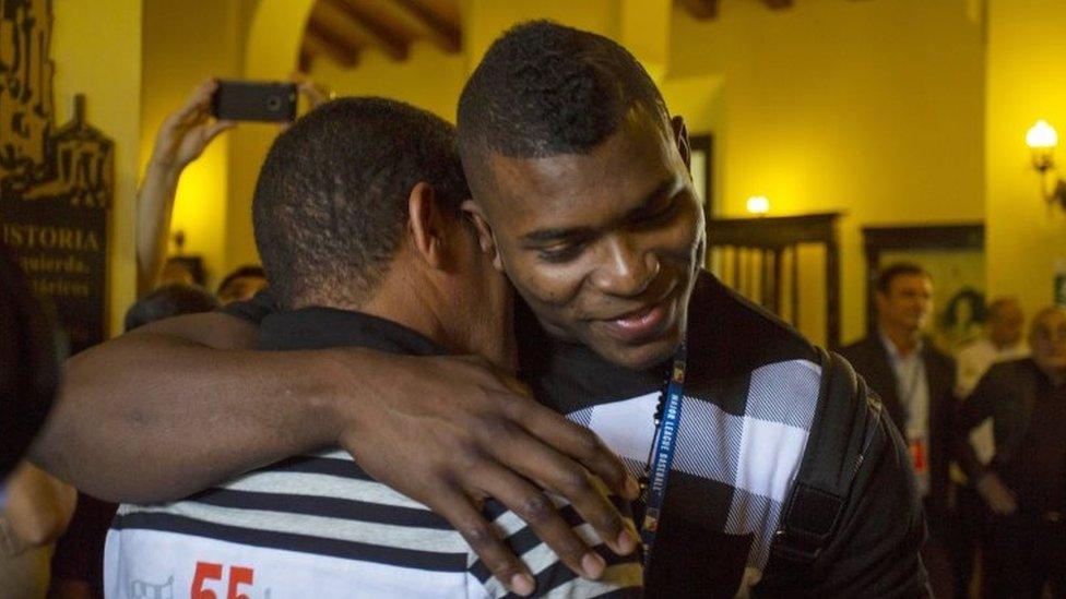 Los Angeles Dodgers outfielder Yasiel Puig, right, hugs his former coach Juan Arechavaleta as he arrives to Hotel Nacional in Havana, Cuba, Tuesday, Dec. 15, 2015.