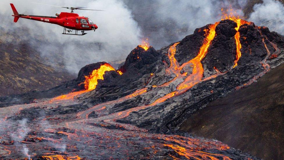 Helicopter near erupting volcano