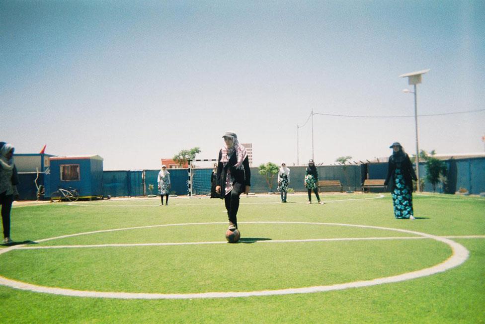 A group of girls play football