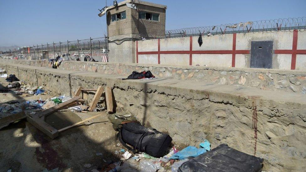 A suitcase and backpacks of Afghan people who were waiting to be evacuated are seen at the site of the attack, which killed scores of people including 13 US troops, at Kabul airport