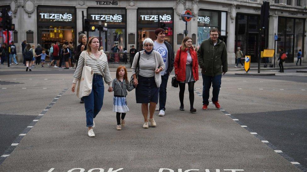 pedestrians crossing road.