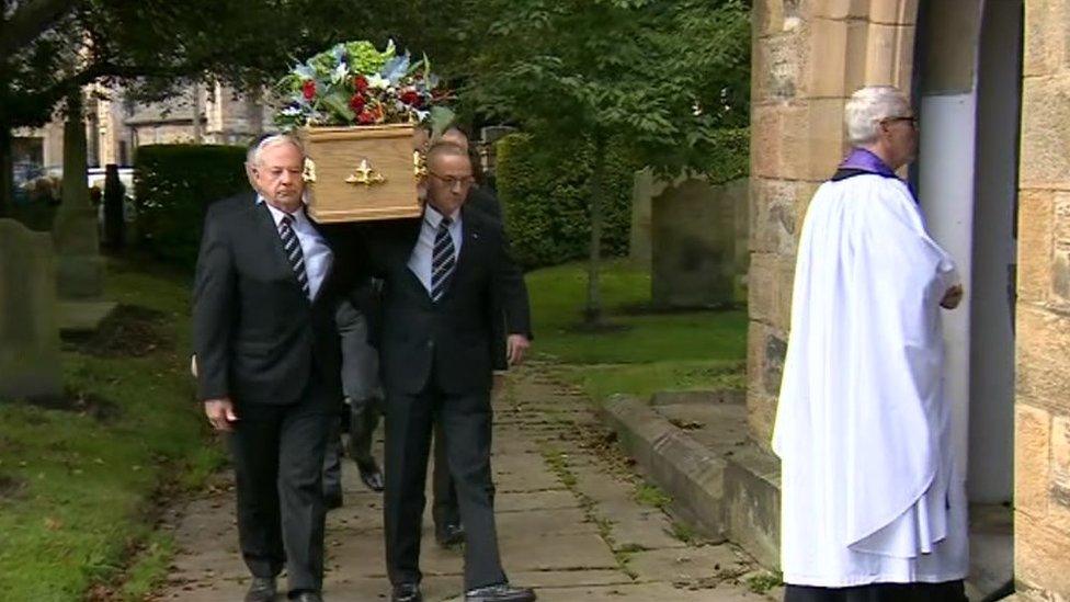 Mike Neville's coffin being taken towards the church