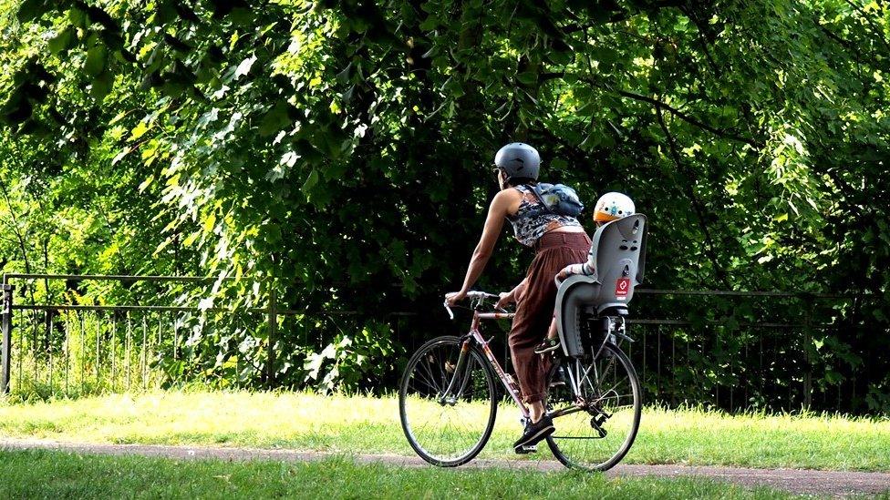 A woman and child on a bike