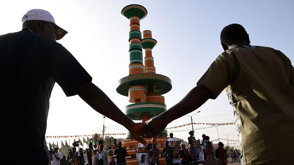 People hold portraits of African film Directors on the place des Cineastes in Ouagadougou, Burkina Faso, during the FESPACO, the Panafrican Film and Television Festival of Ouagadougou, on Febuary 24, 2019.