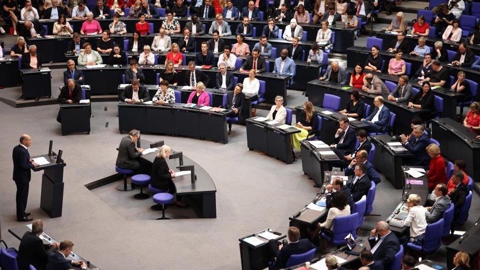 German Chancellor Olaf Scholz delivers a government statement at the German parliament