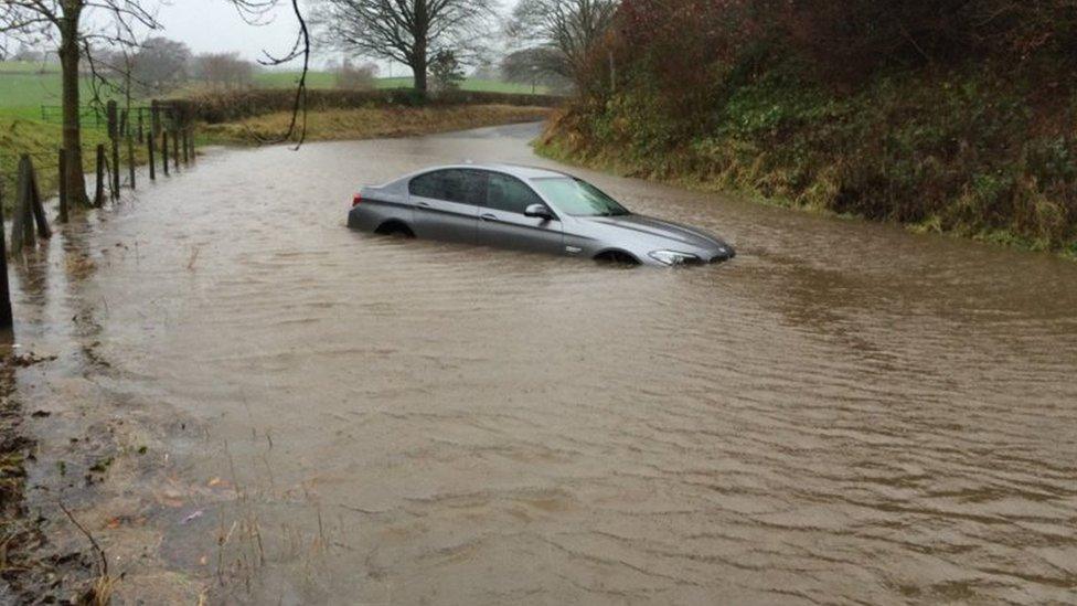 Car in flood water on A684