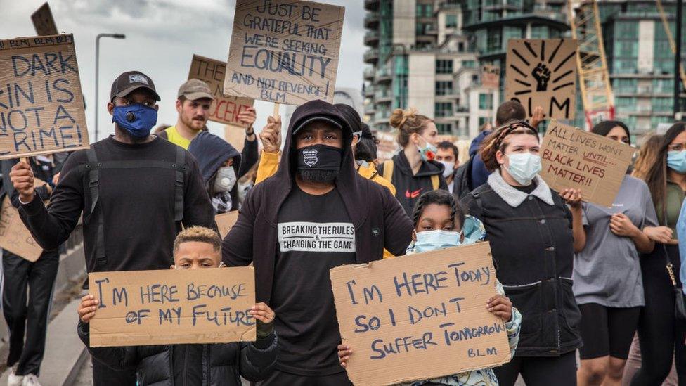 Black Lives Matter protester with two children