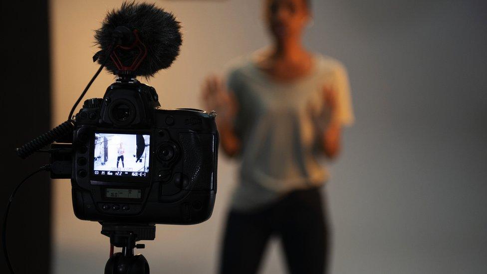 Stock photo of an actress in front of the camera in an audition