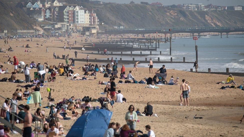 People enjoy the warm weather on Bournemouth beach in Dorset.