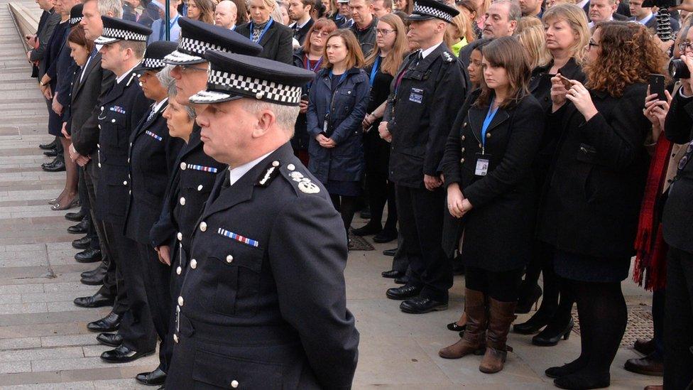 Police and staff pause for a silence