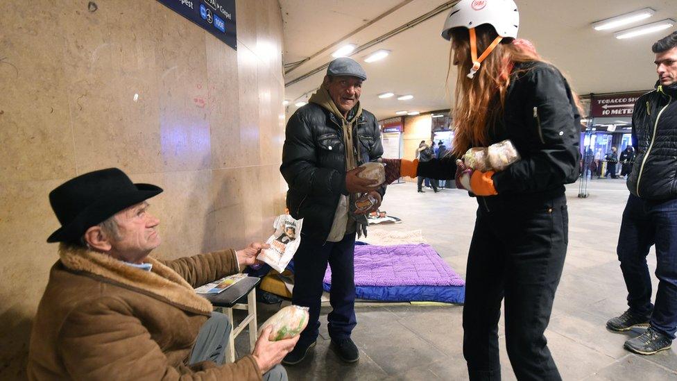 Students give food to the homeless in Hungary