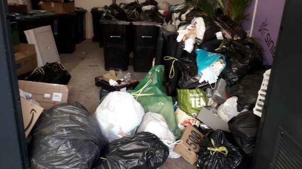 Used face masks spilling out of rubbish bag