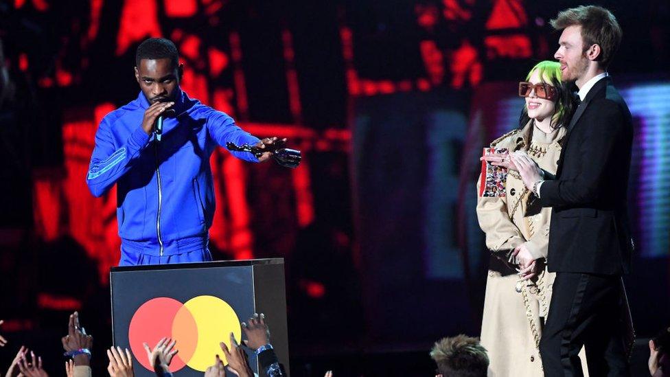 Dave-on-stage-collecting-award-with-Billie-Eilish-on-stage.