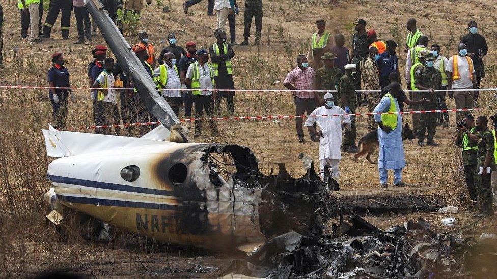 People and rescuers gather at the site where a Nigerian air force plane crashed while approaching the Abuja airport runway, according to the aviation minister, in Abuja, Nigeria February 21, 2021.