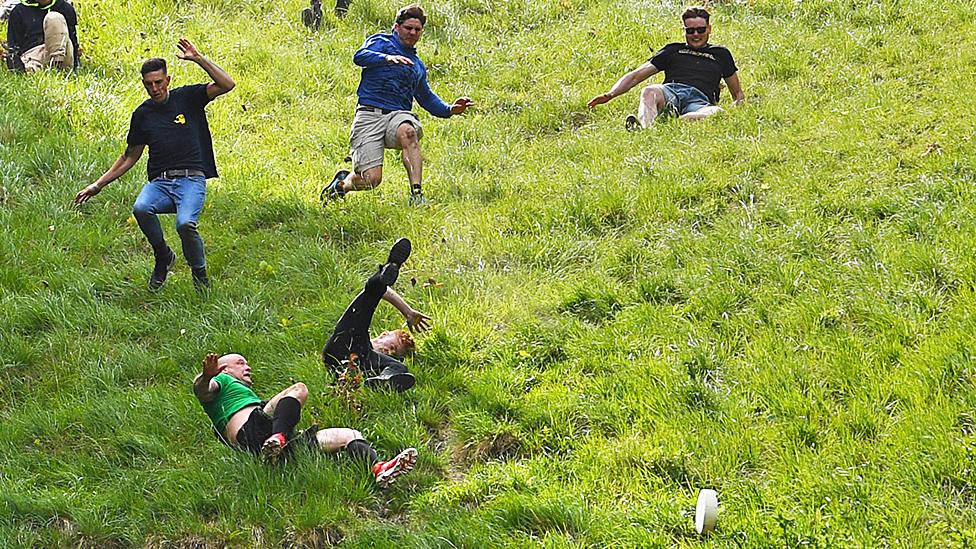 Participants take part in the second Cooper's hill men's downhill race on May 29, 2023 in Gloucester, United Kingdom