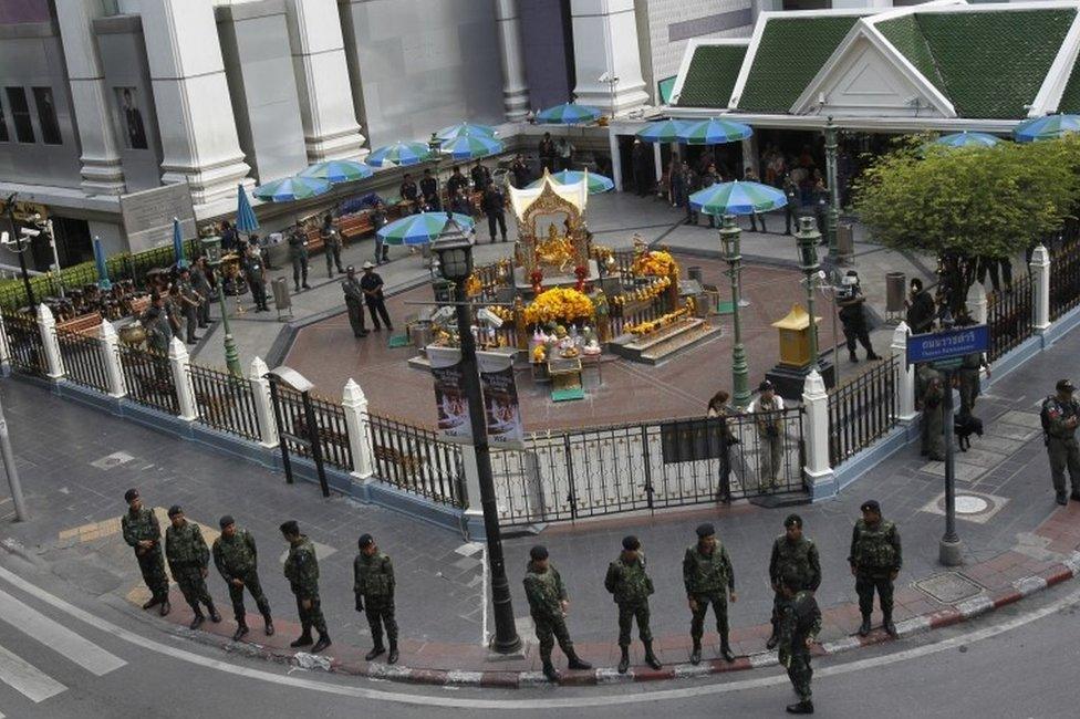 Thai soldiers stand guard outside Erawan Shrine before a key suspect in last month's Bangkok bombing, identified as Adem Karadag, arrives for a reenactment of the August 17 bombing at Bangkok's popular Erawan Shrine Saturday, Sept 26, 2015.