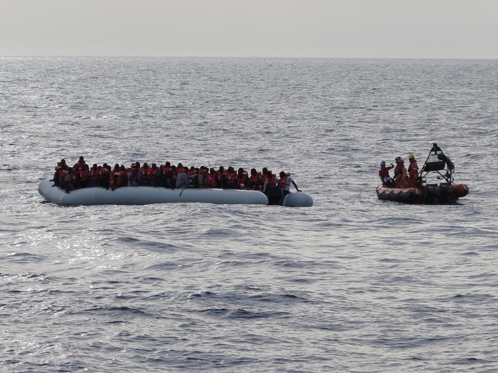 Rescue boat approaches a migrant dinghy