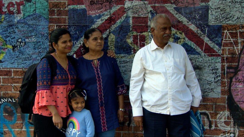 A family visit a Belfast peace wall