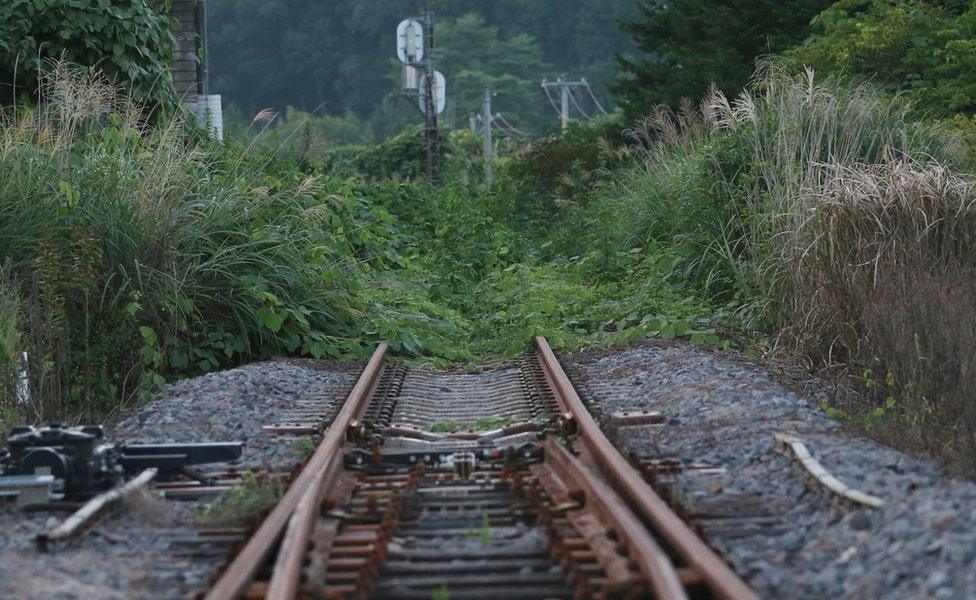 The rusty train track of the Joban line is covered with weeds near Tatsuta Station in Naraha town - the first of seven evacuated towns to reopen since the 2011 disaster