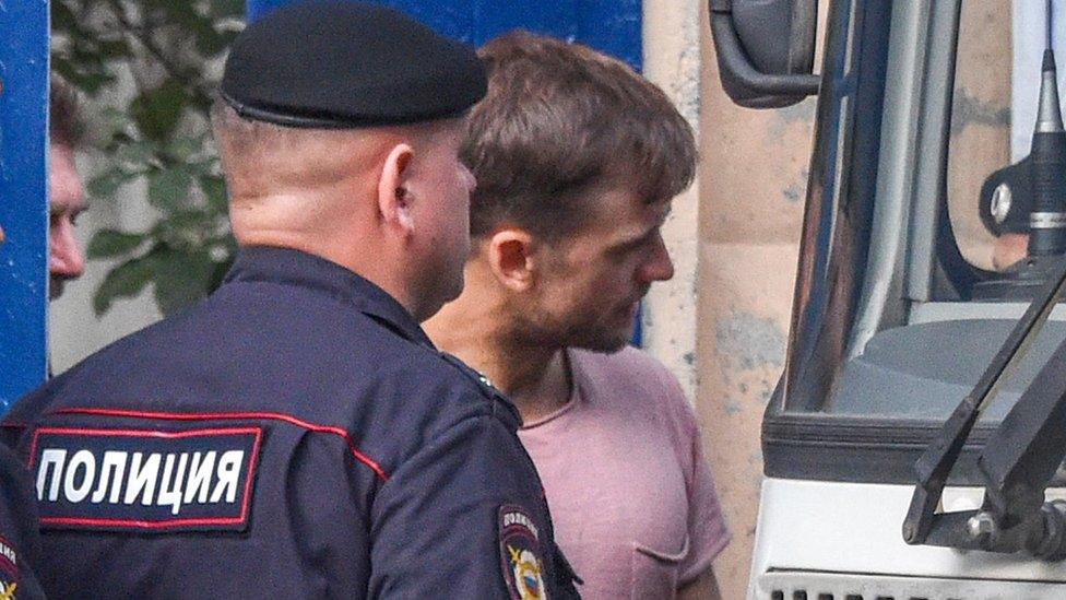 The Pussy Riot punk group member Pyotr Verzilov (R) leaves a detention centre in Moscow on July 30, 2018