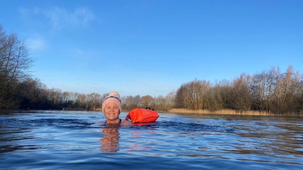 Dinah swimming, with a floatation device