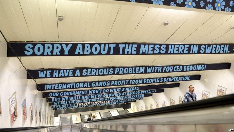 A view of the adverts posted above one escalator apologising to tourists for "forced begging"