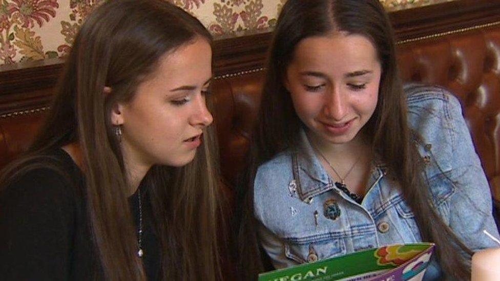 Cerys and Cadi Davage holding a menu