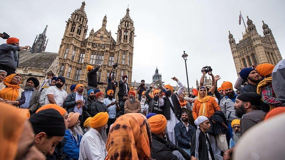 Protestors block the roads in Parliament Square, opposite Britain's Houses of Parliament in central London on 15 July, 2015, during a demonstration calling for the release of Sikh political prisoners in India,