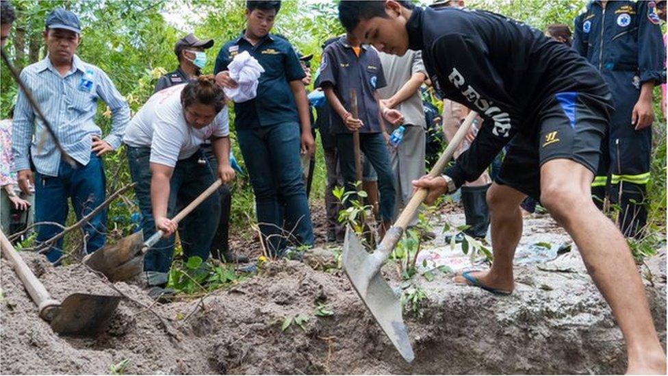 Thai volunteers exhume unmarked migrant graves in the forest