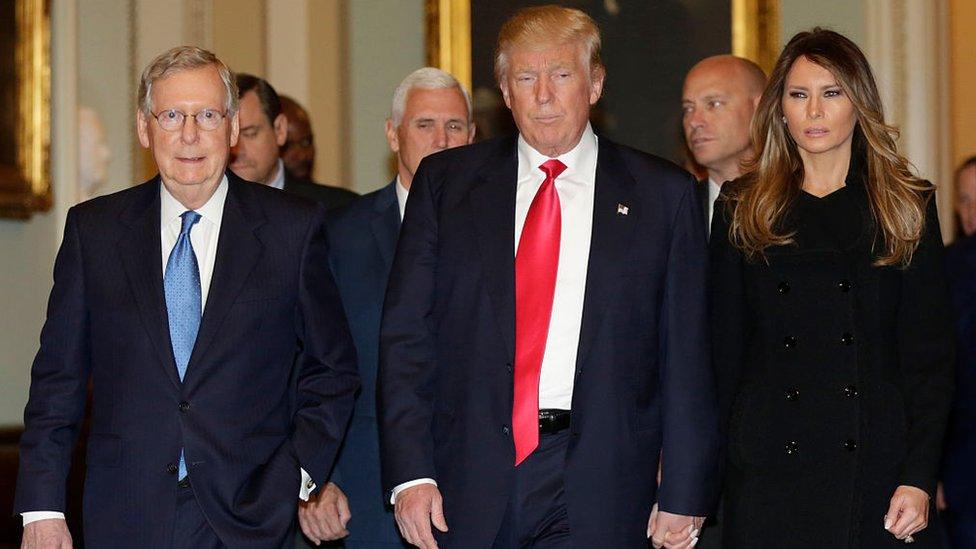 President-elect Donald Trump (C) walks with his wife Melania Trump and Vice President-elect Mike Pence (2nd L) before a meeting with Senate Majority Leader Mitch McConnell(L)