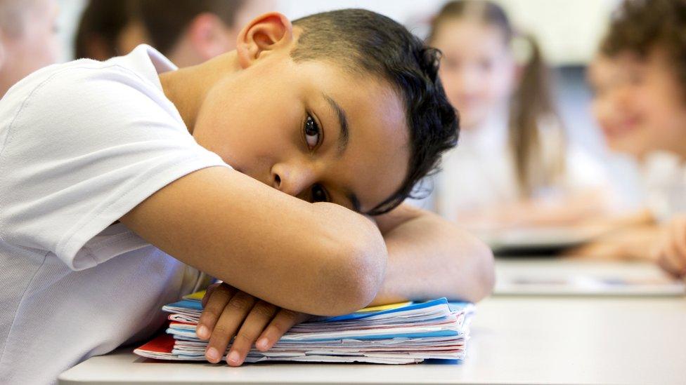 boy-at-school-with-head-on-desk.