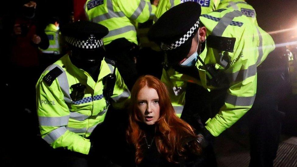 Police at Clapham Common handcuff a woman