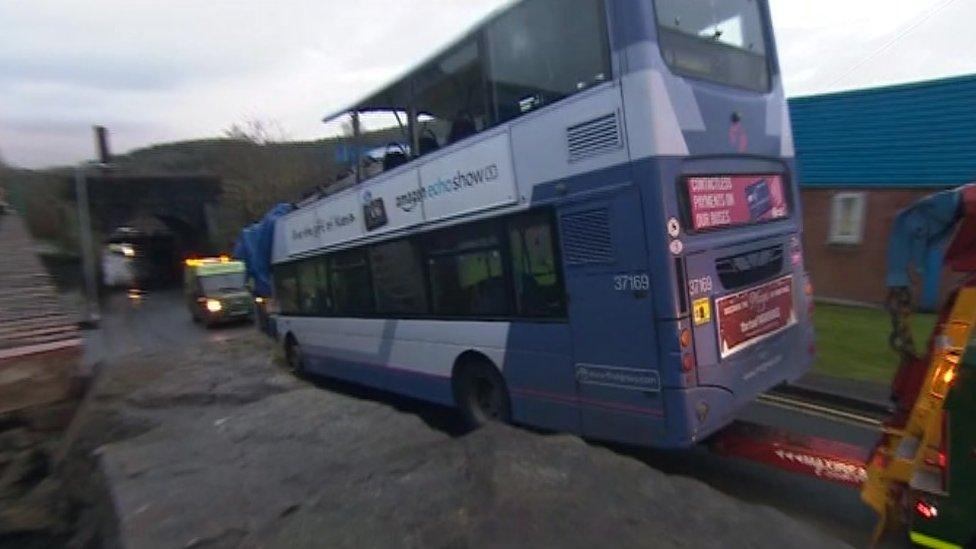 The bus being towed from the scene