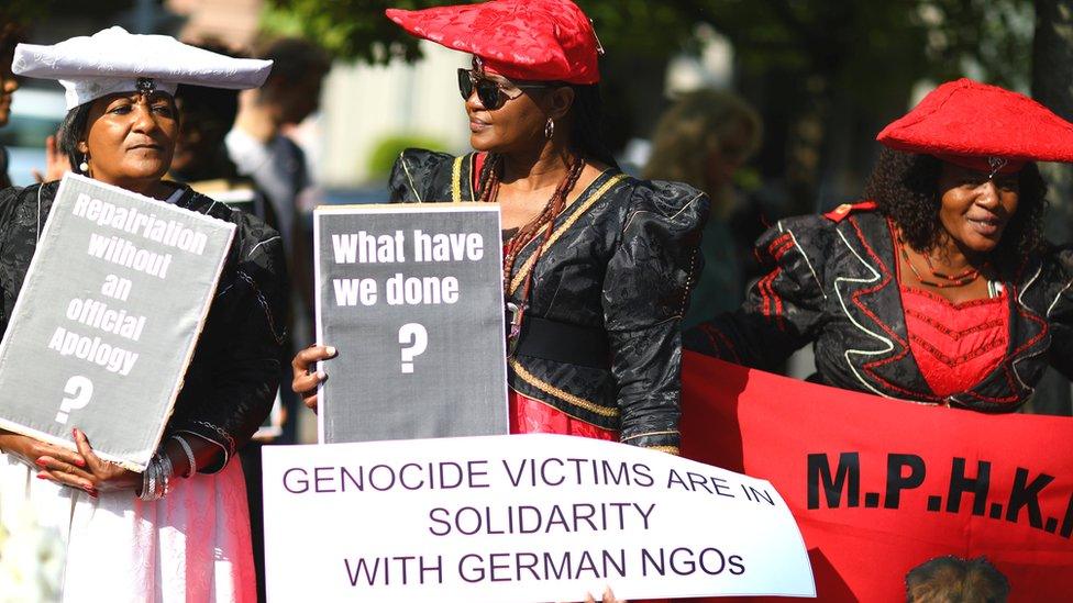 Namibians protest outside a ceremony in Berlin, Germany to hand back human remains from Germany to Namibia following the 1904-1908 genocide against the Herero and Nama - Wednesday 29 August 2018