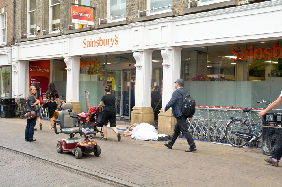 People sleeping and begging outside Sainsbury