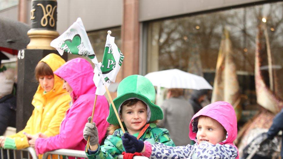 Children waving flags along the parade