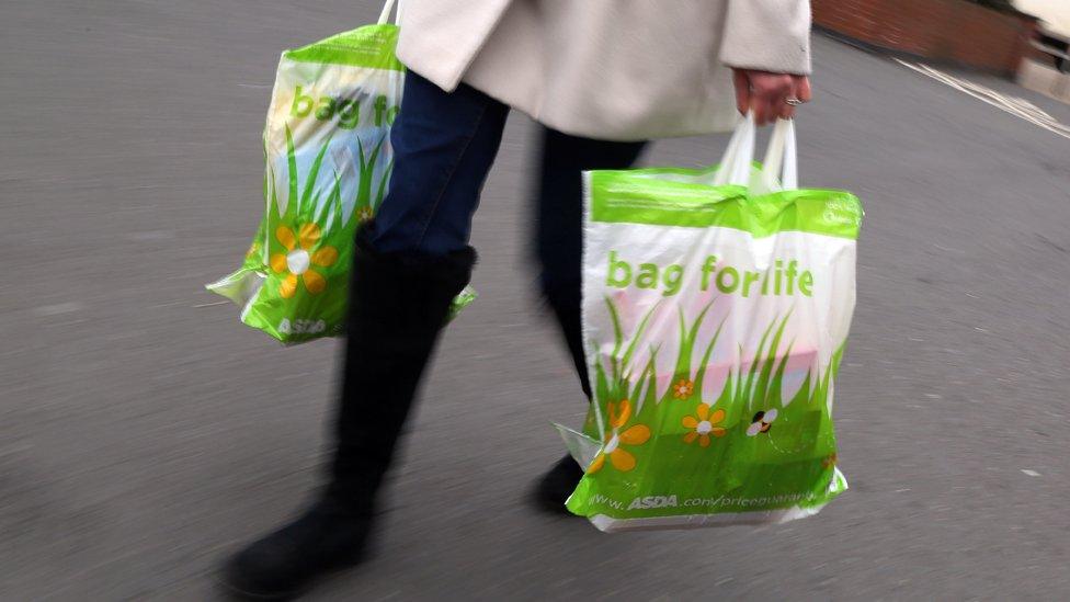 Woman carrying two bags for life