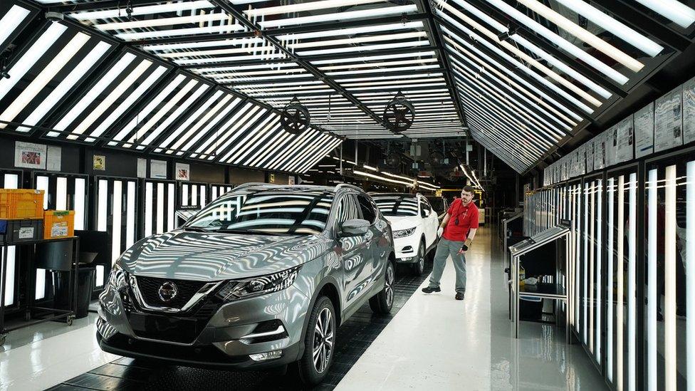 Man inspecting car in factory