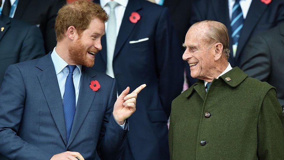 Princes Philip and Harry laughing