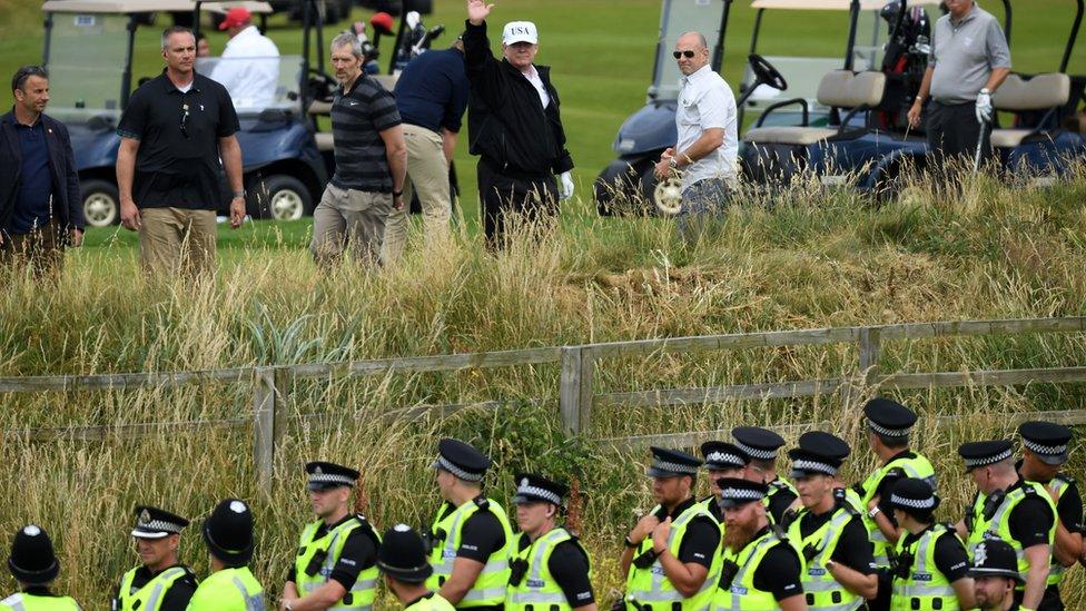 Donald Trump and police at the Turnberry golf course in Scotland