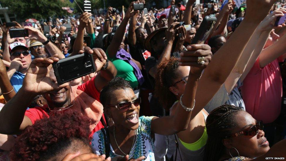 The crowd cheers as the Confederate flag is lowered from South Carolina's state grounds in Columbia, South Carolina - 10 July 2015