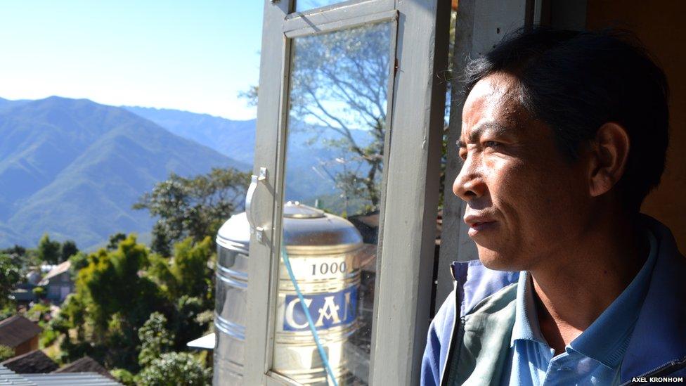 Ex-opium farmer looks out onto agricultural land