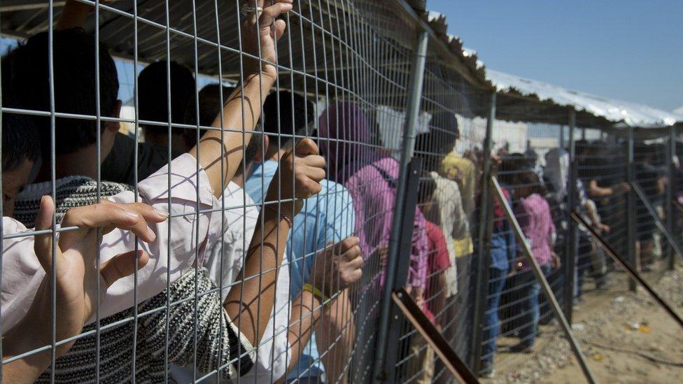 Migrants wait for the distribution of aid at Idomeni, Greece, Monday, May 23, 2016